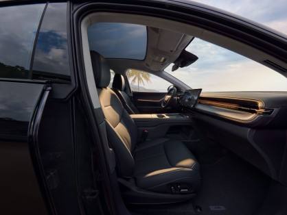 Gray-toned upholstery with suede texture and ambient lighting enhances the cabin’s cocoon-like ambiance