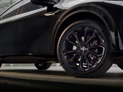 Smoked alloy wheels paired with black calipers underscore the model’s high-performance attitude